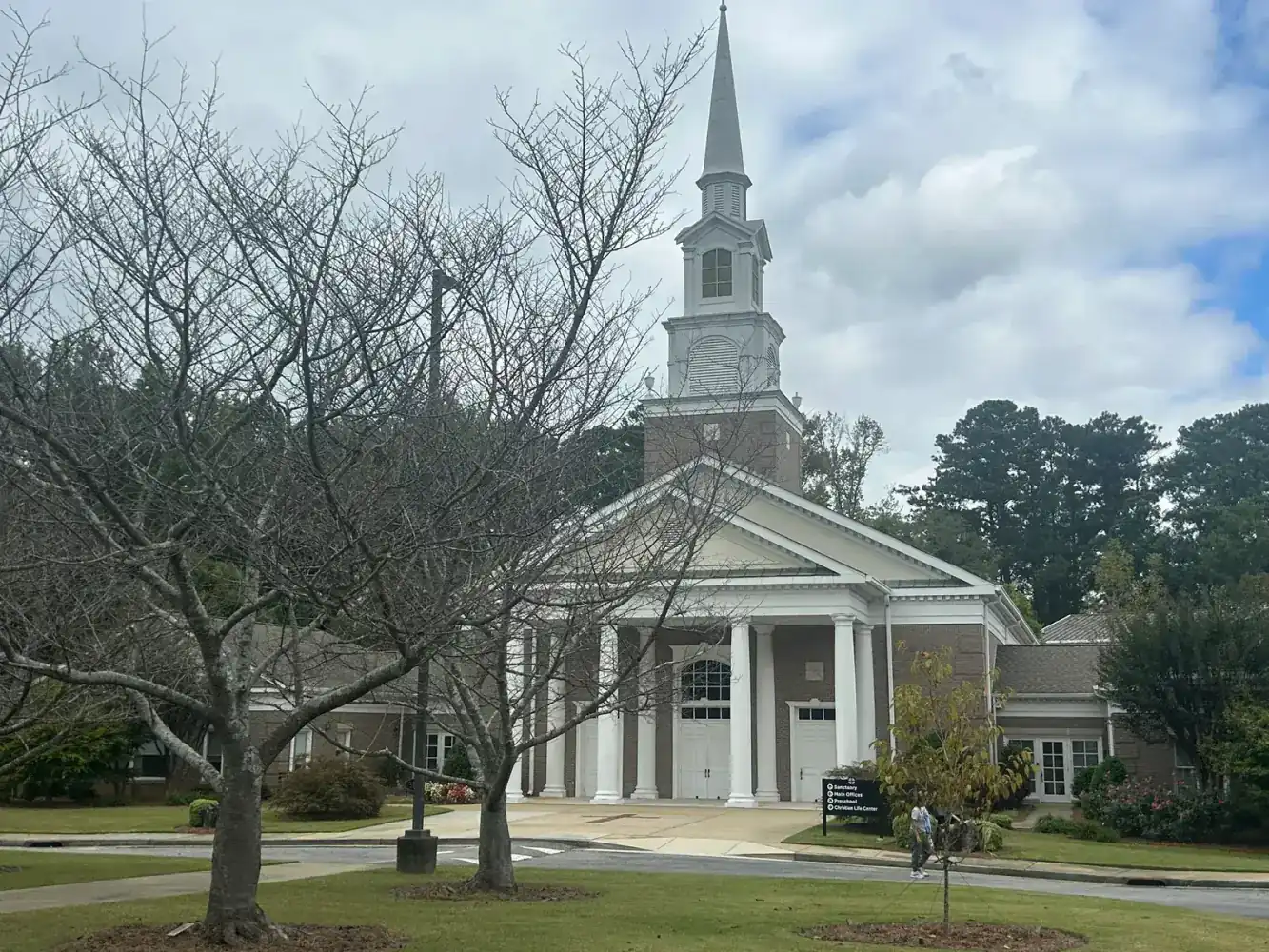 Brick church with white steeple and columned entrance in Georgia