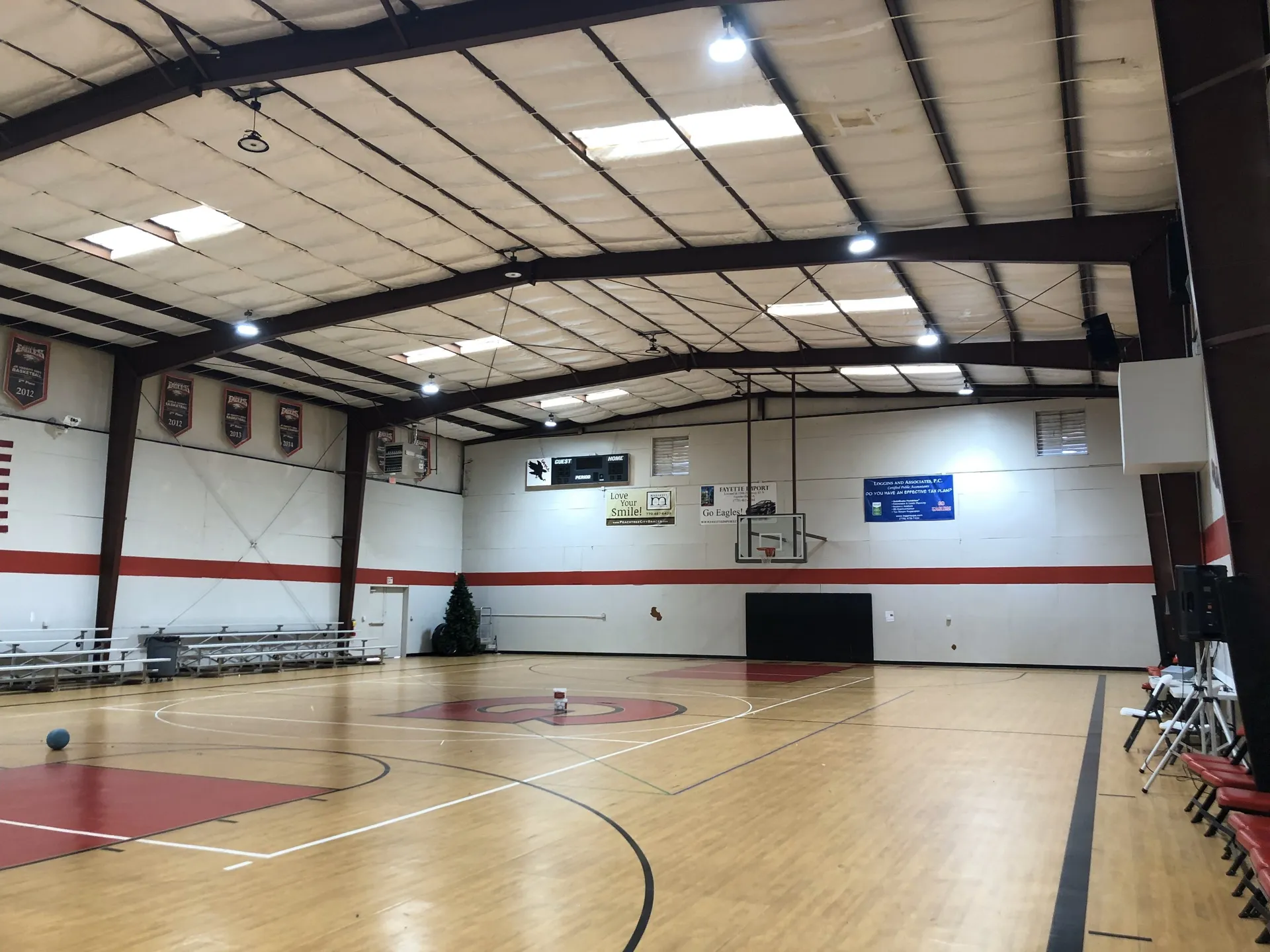 Church school gymnasium with basketball court and bleachers