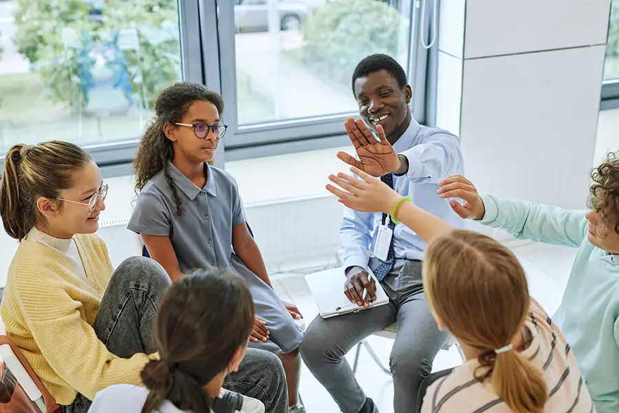 social worker in group therapy with teens