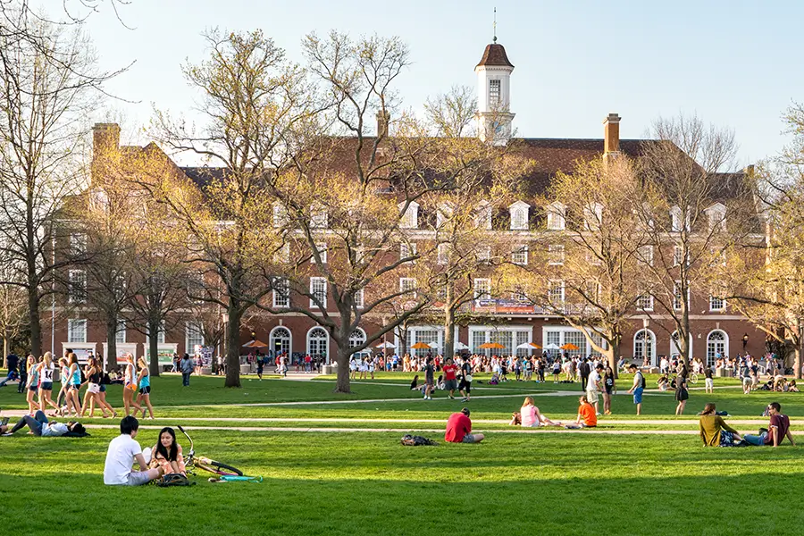 Students sitting on the lawn of a college campus