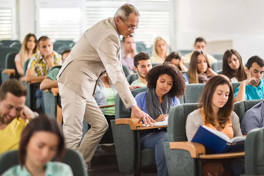 students and a teacher in a college classroom