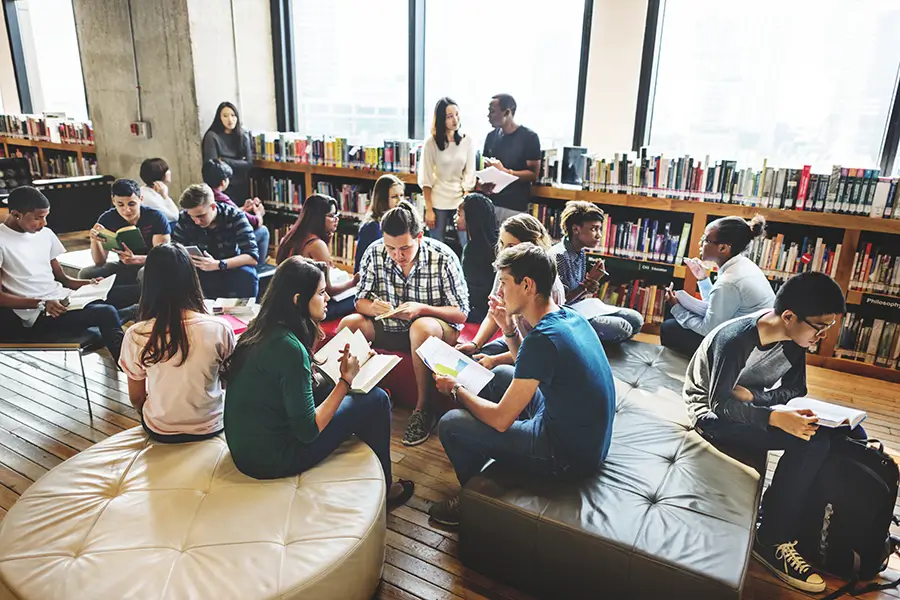 students sitting in discussion groups at a university library