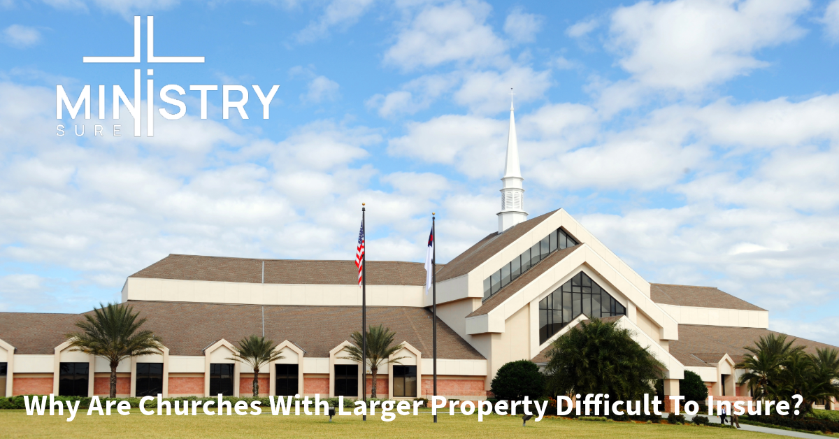 A large, modern church building with a tall white steeple against a blue sky with scattered clouds. The church has a well-maintained lawn with palm trees and is accompanied by the MinistrySure logo. The text "Why Are Churches With Larger Property Difficult To Insure?" is displayed at the bottom.